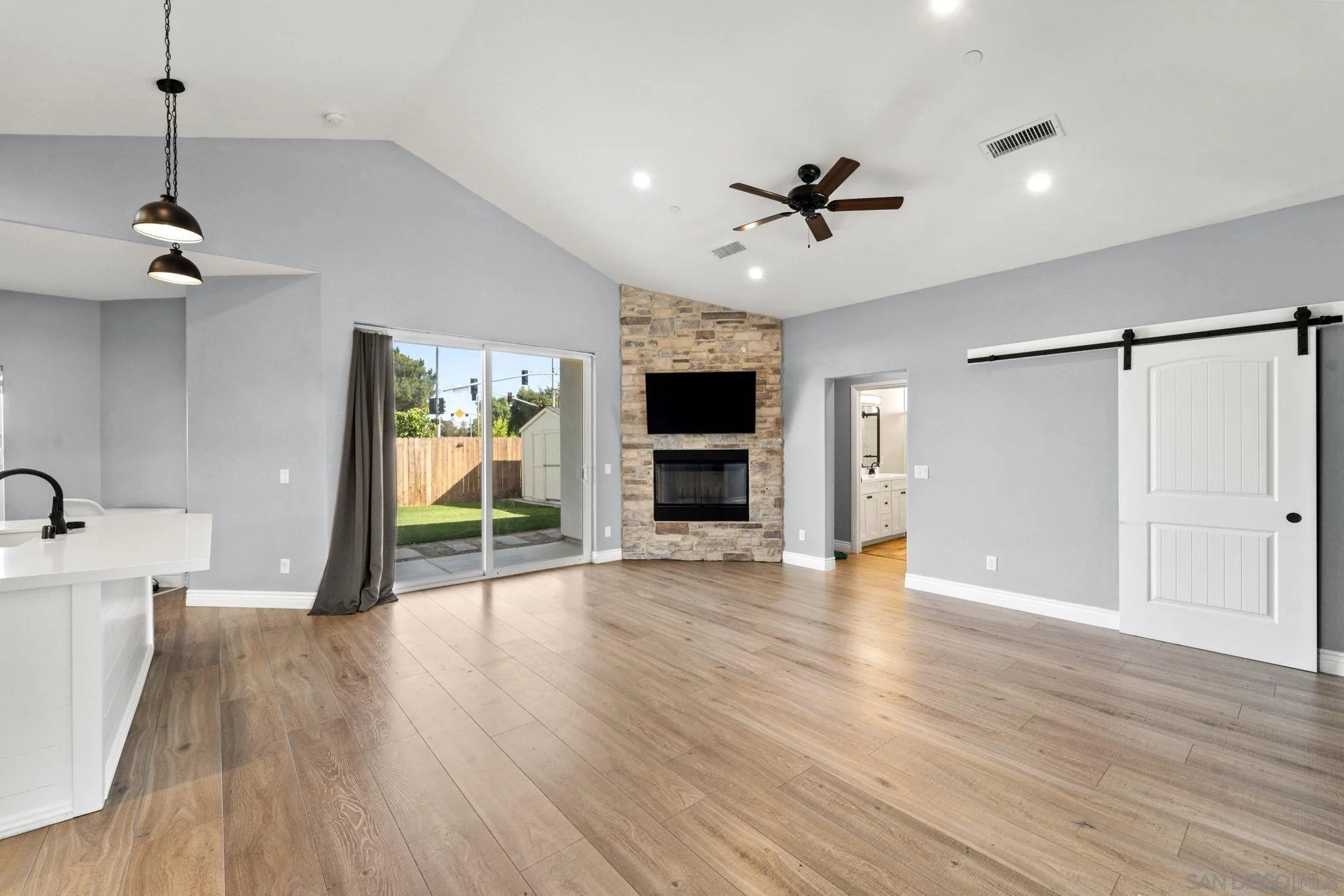 940 Passion Place Ramona, CA 92065 - Photo 5 of 25 a view of a livingroom with wooden floor and a ceiling fan