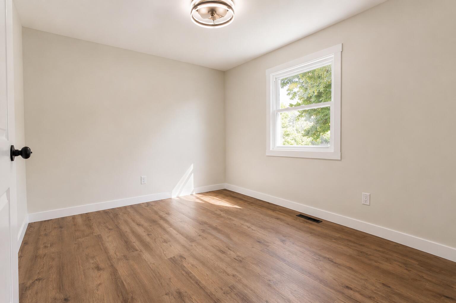 414 Holly Road Michigan City, IN 46360 - Photo 24 of 41 an empty room with wooden floor and windows