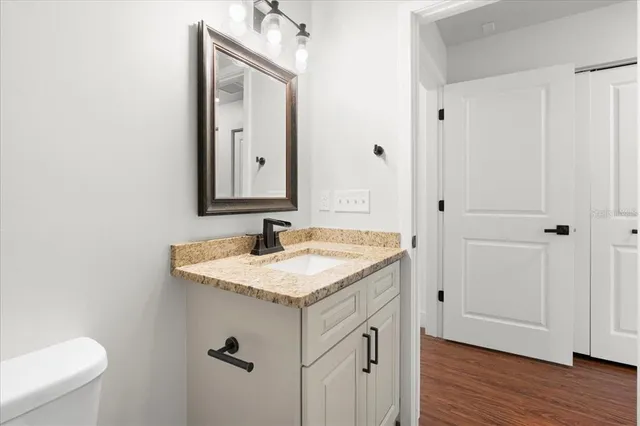 a bathroom with a granite countertop sink and a mirror