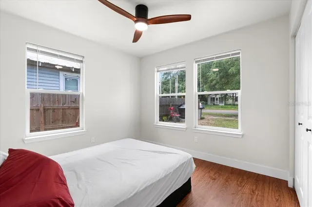 a bedroom with a bed and a window