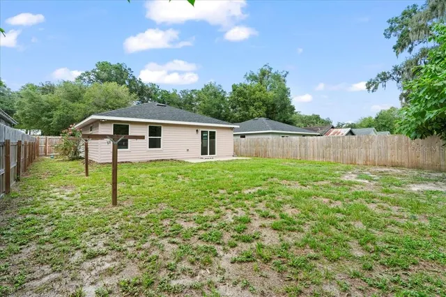 a backyard of a house with table and chairs