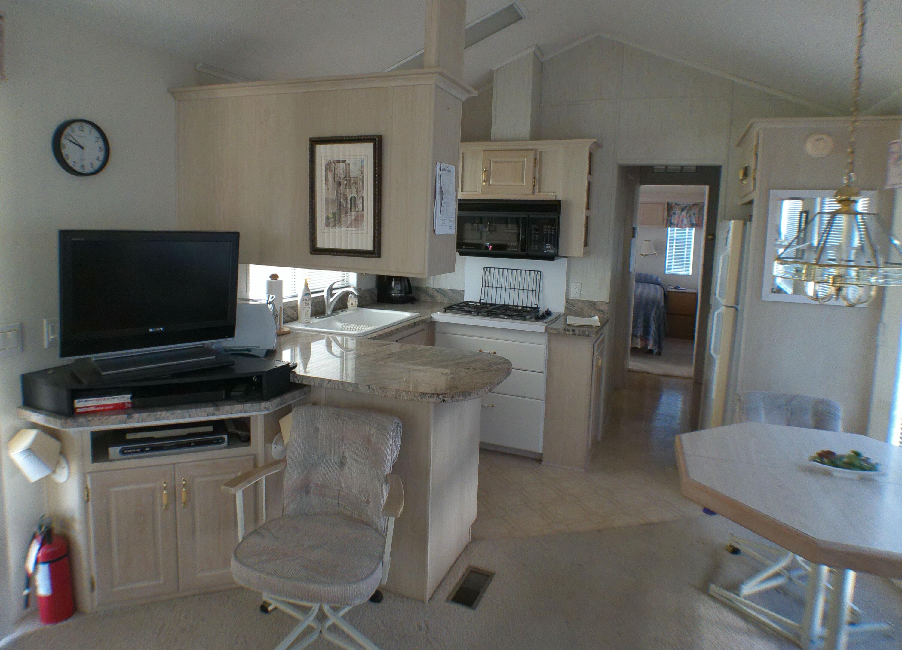 84136 Ave 44, Unit 337 Indio, CA 92203 - Photo 16 of 31 a kitchen with a stove a microwave and refrigerator