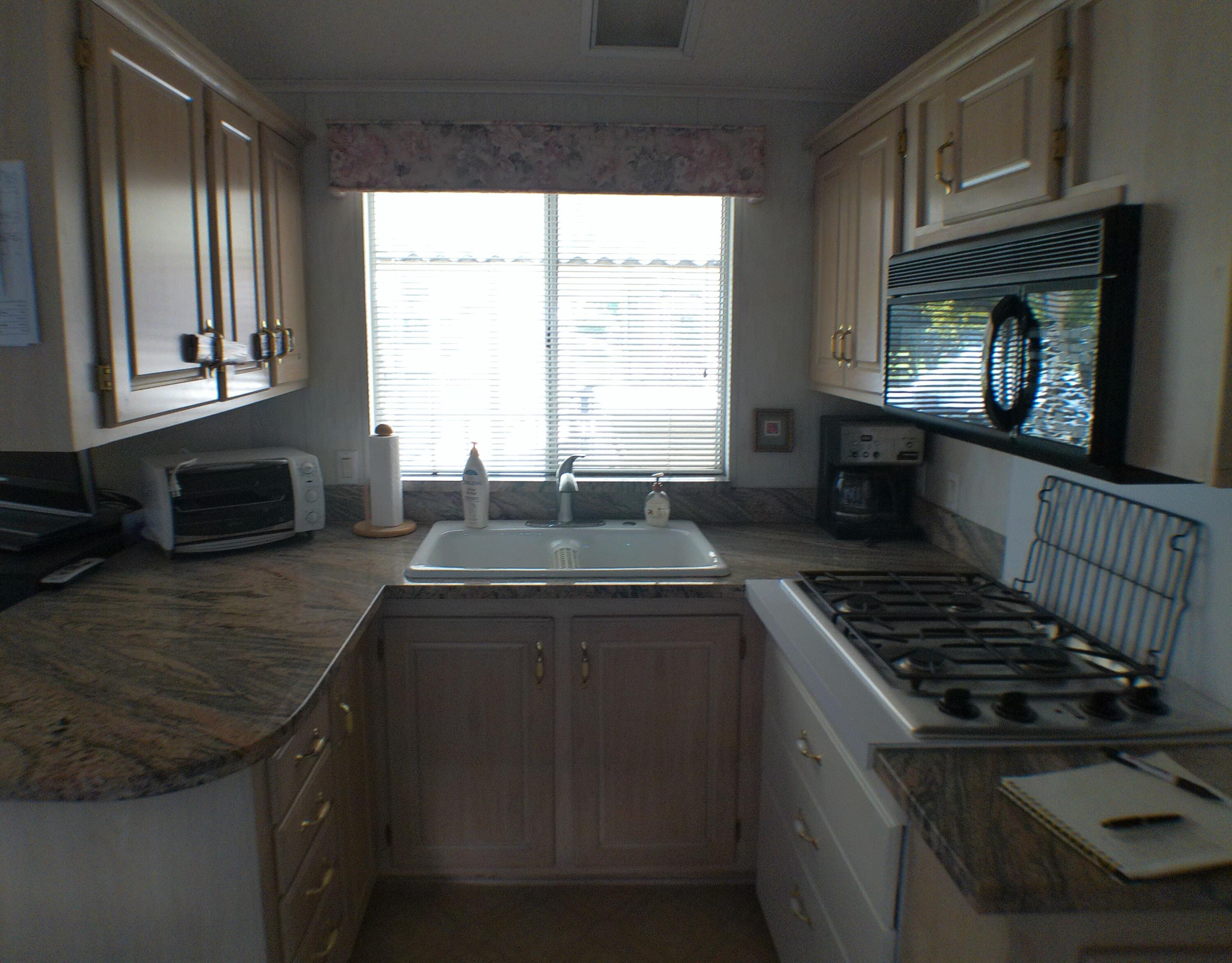 84136 Ave 44, Unit 337 Indio, CA 92203 - Photo 17 of 31 a kitchen with granite countertop a stove and a sink