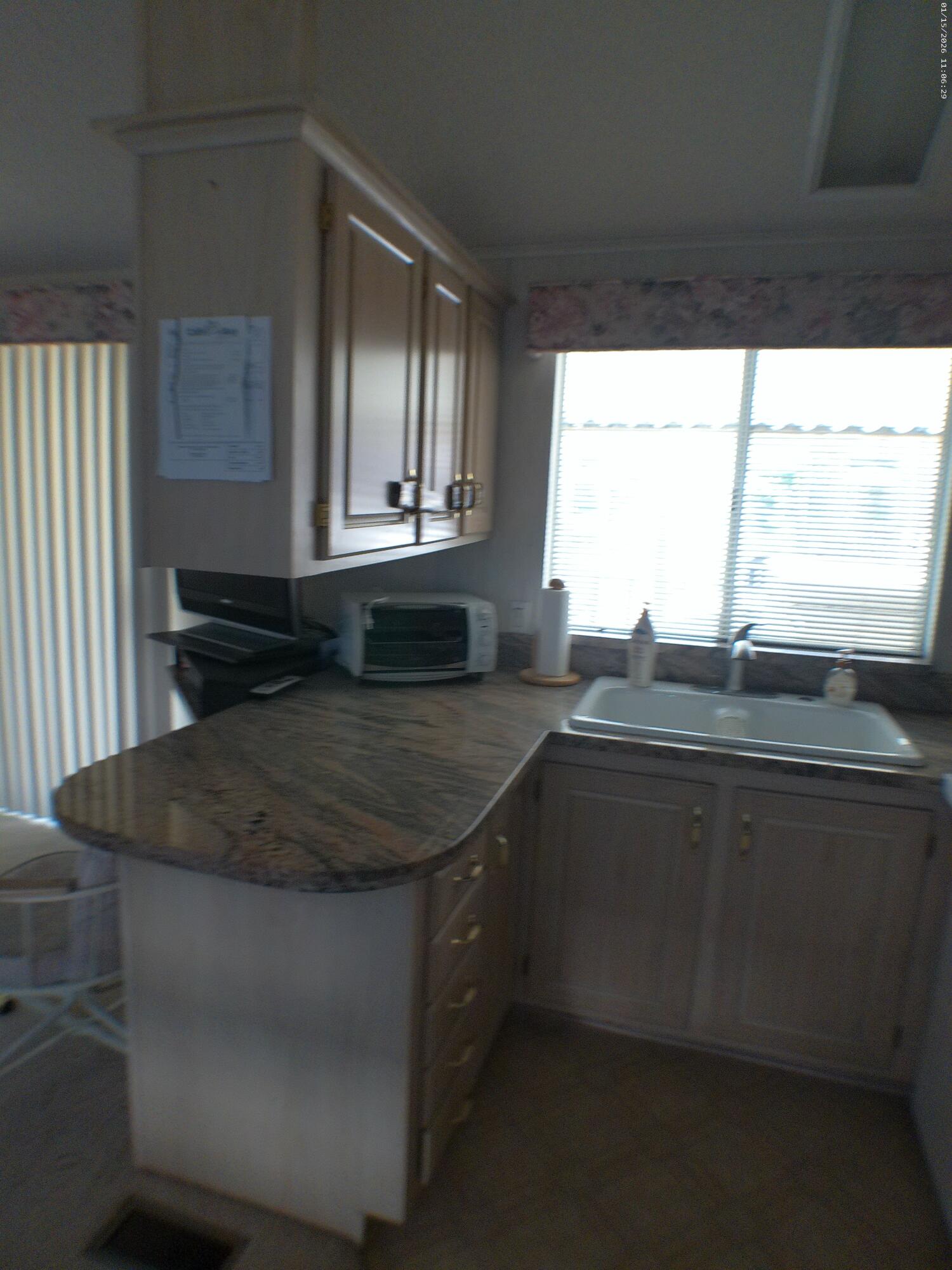 84136 Ave 44, Unit 337 Indio, CA 92203 - Photo 18 of 31 a kitchen with kitchen island sink and window
