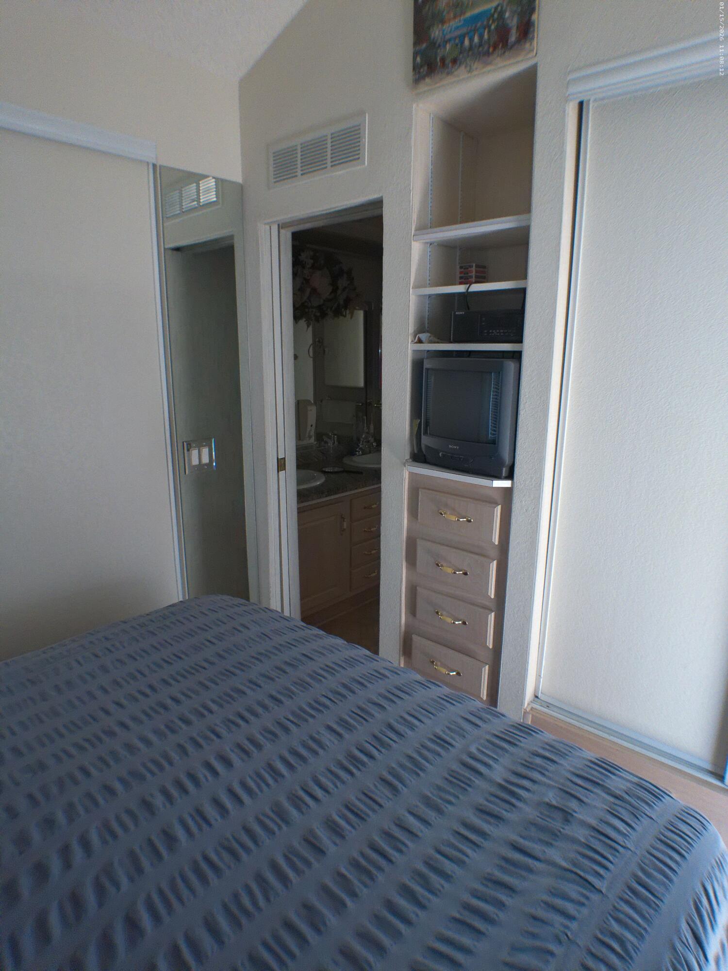 84136 Ave 44, Unit 337 Indio, CA 92203 - Photo 28 of 31 a view of a hallway with wooden floor and cabinet