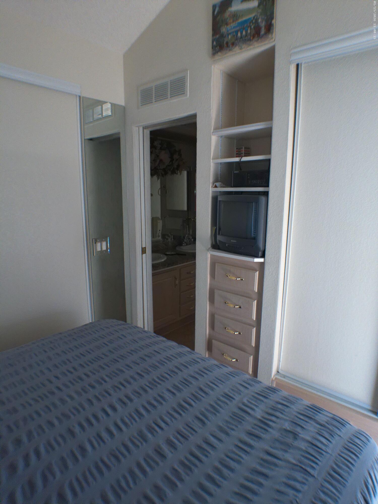 84136 Ave 44, Unit 337 Indio, CA 92203 - Photo 29 of 31 a view of a bedroom with closet and cabinet