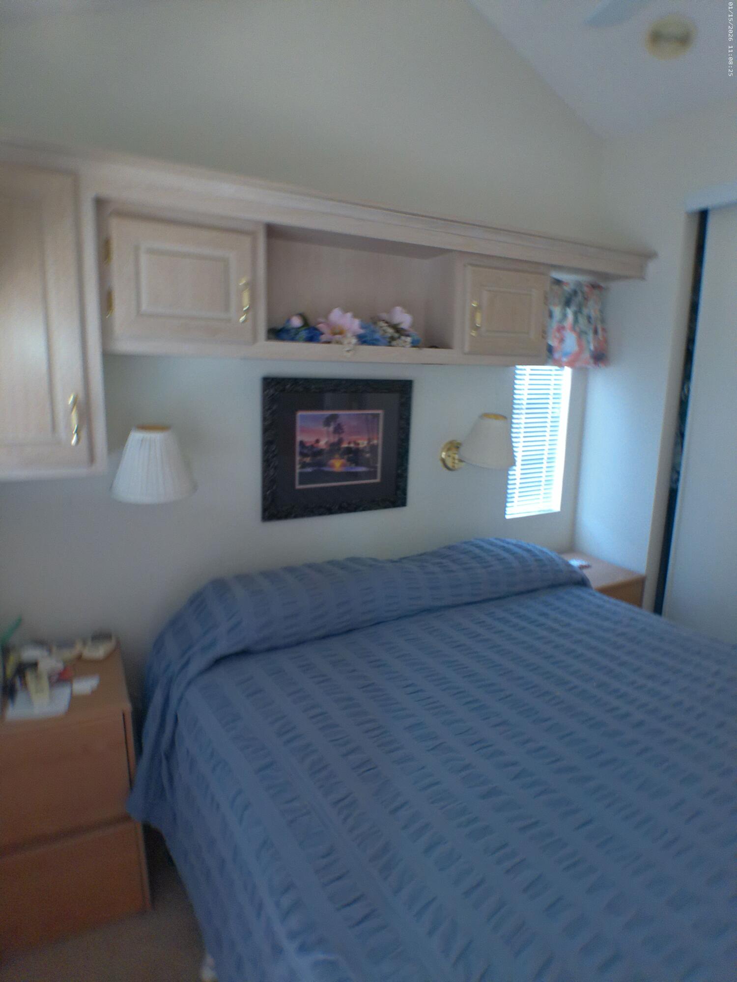 84136 Ave 44, Unit 337 Indio, CA 92203 - Photo 30 of 31 a bedroom with a bed and a window