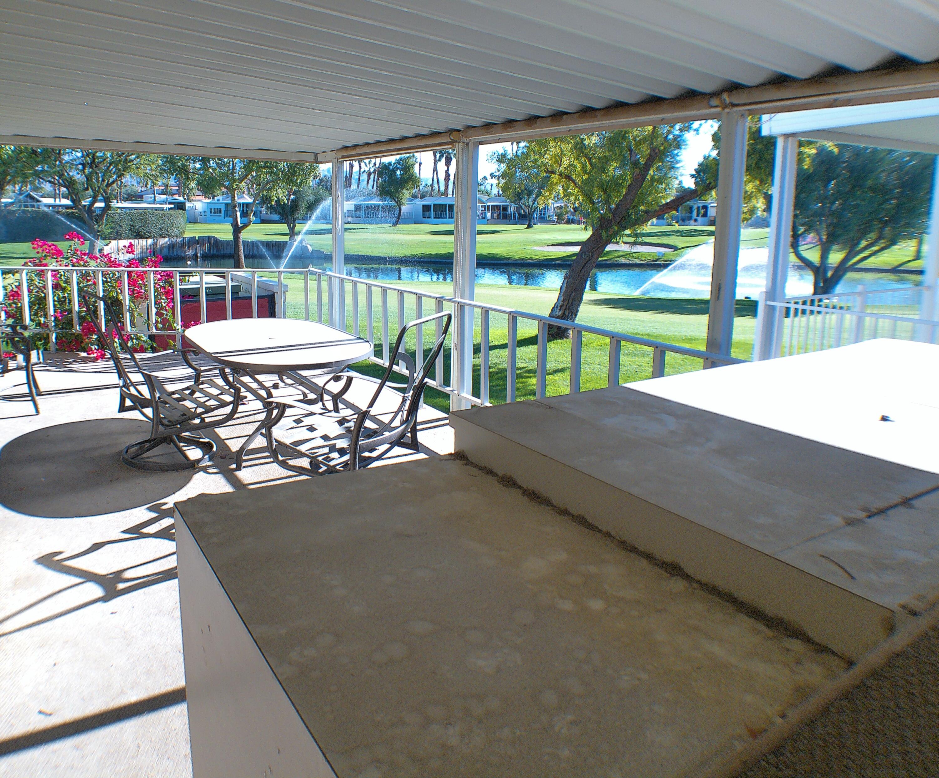 84136 Ave 44, Unit 337 Indio, CA 92203 - Photo 3 of 31 a view of a patio with a table chairs and a backyard