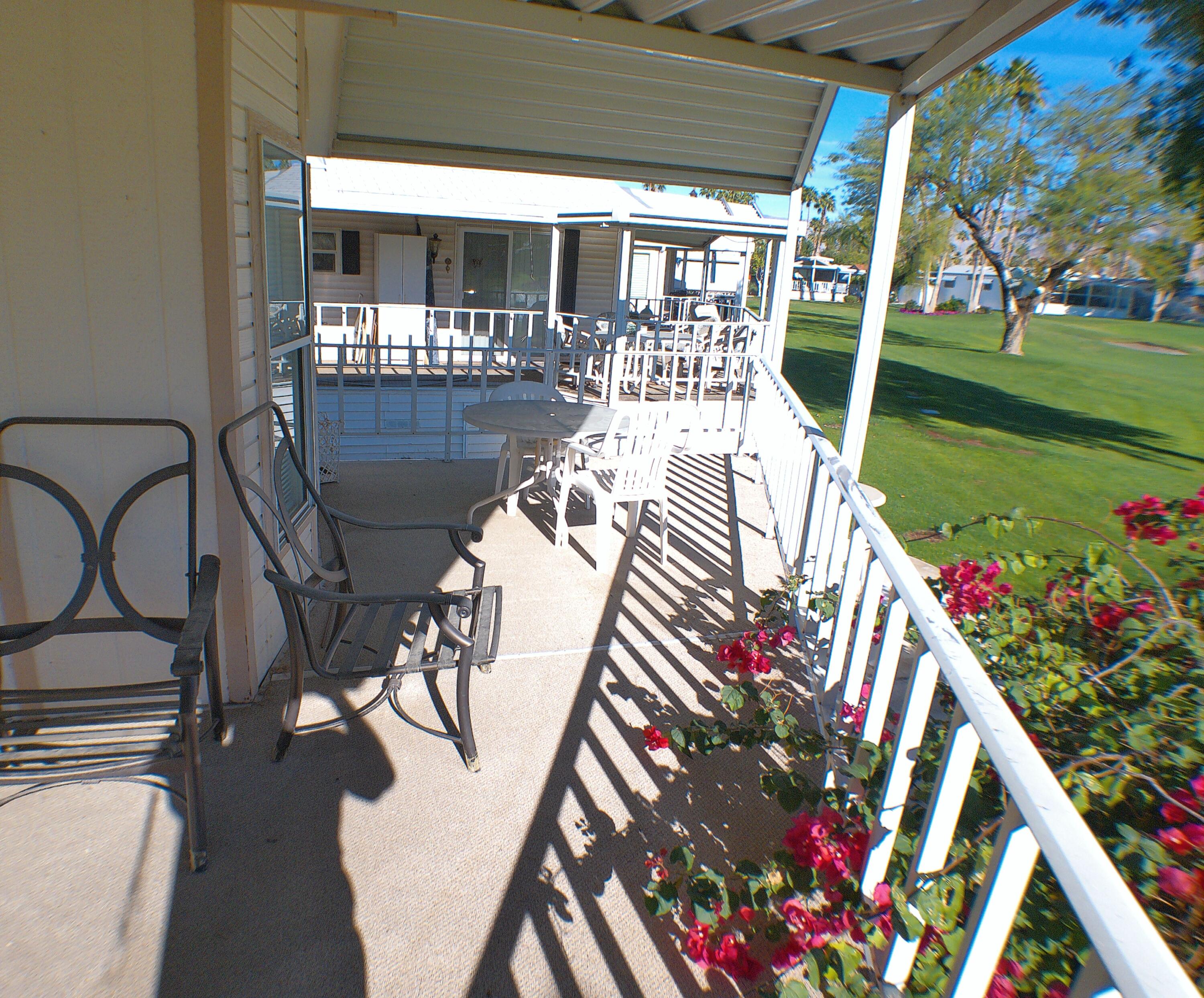84136 Ave 44, Unit 337 Indio, CA 92203 - Photo 6 of 31 a view of a porch with chairs and potted plants