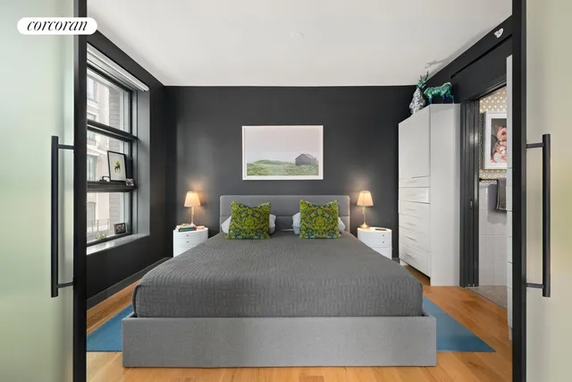 a large bed sitting in a bedroom next to a window