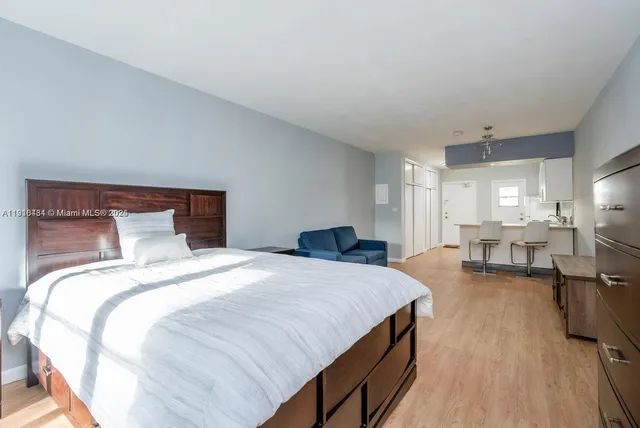 a spacious bedroom with a bed and a table in it