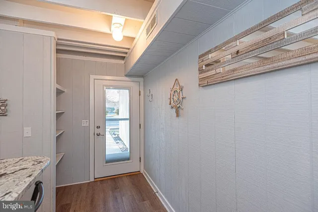 a kitchen with granite countertop a sink stainless steel appliances and cabinets
