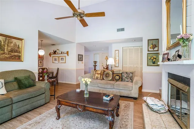 a living room with furniture a flat screen tv and a large window