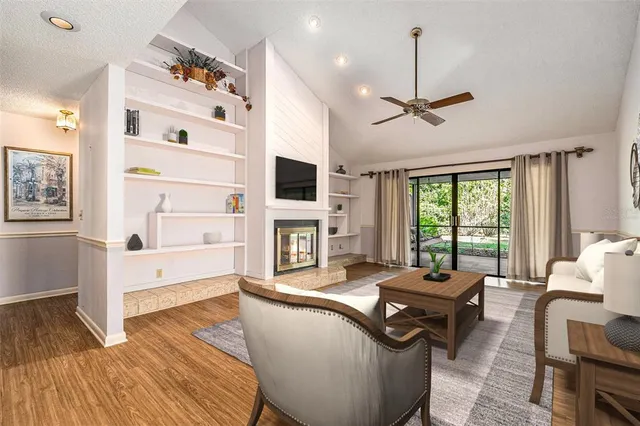 a living room with fireplace furniture and a wooden floor