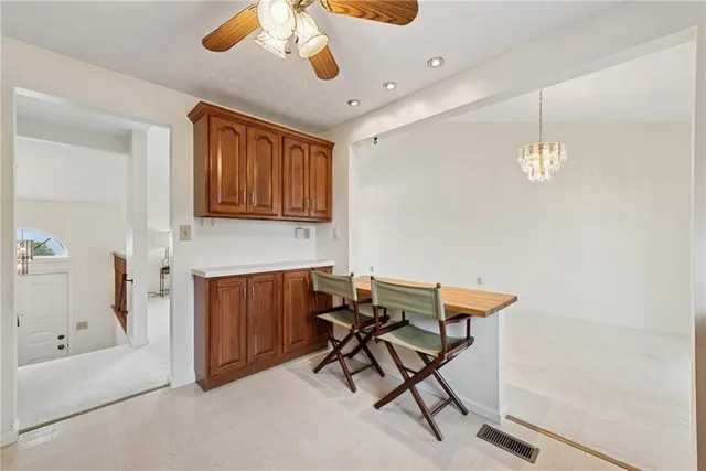 a view of a workspace with furniture and chandelier