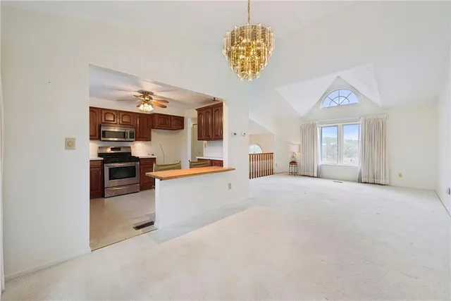 a large kitchen with cabinets and stainless steel appliances