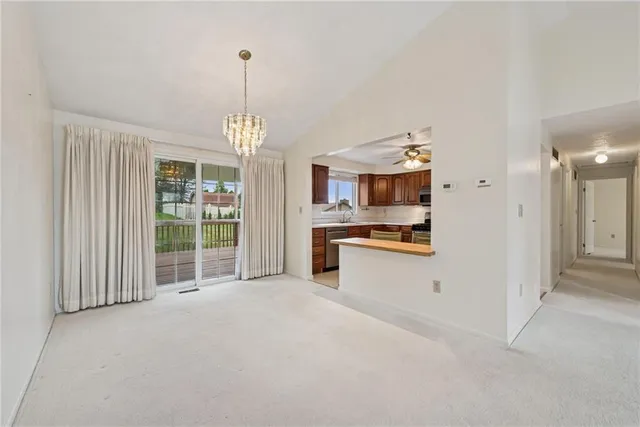 a view of a kitchen with fridge and wooden floor
