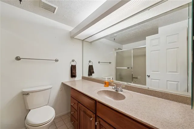 a bathroom with a sink toilet vanity and tub