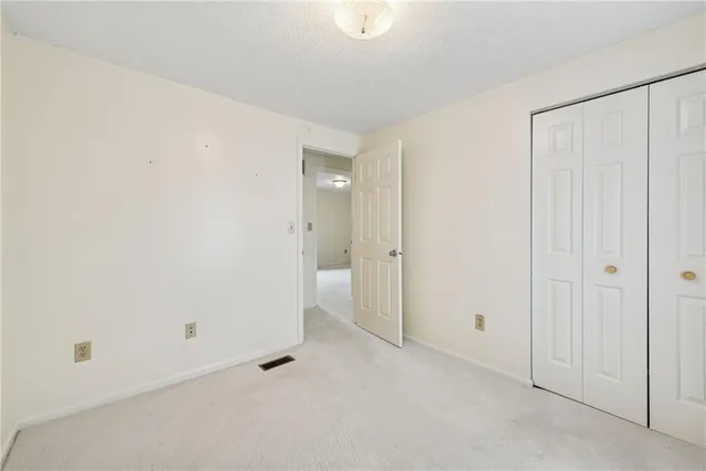 an empty room with a empty space and windows