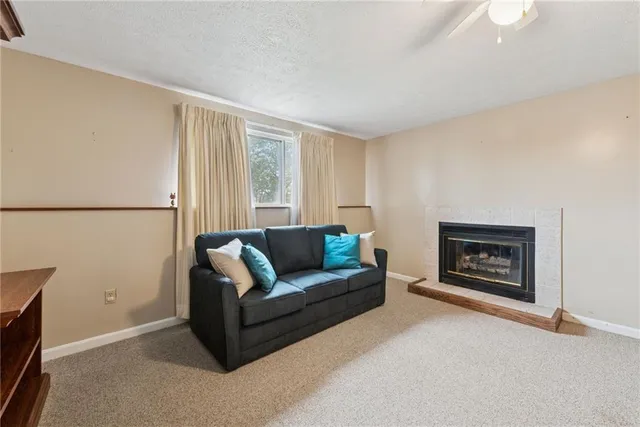 a view of a livingroom with furniture and a ceiling fan