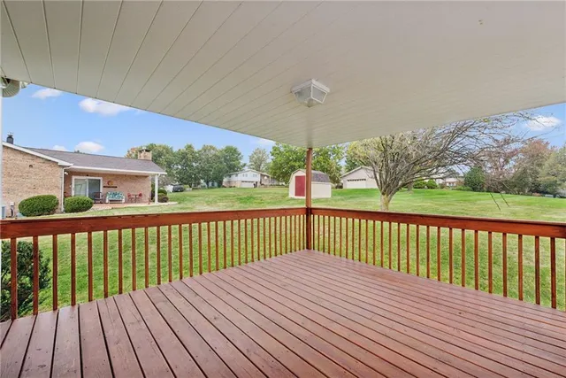 a view of backyard with deck and wooden floor