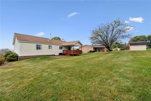 a front view of house with yard and trees