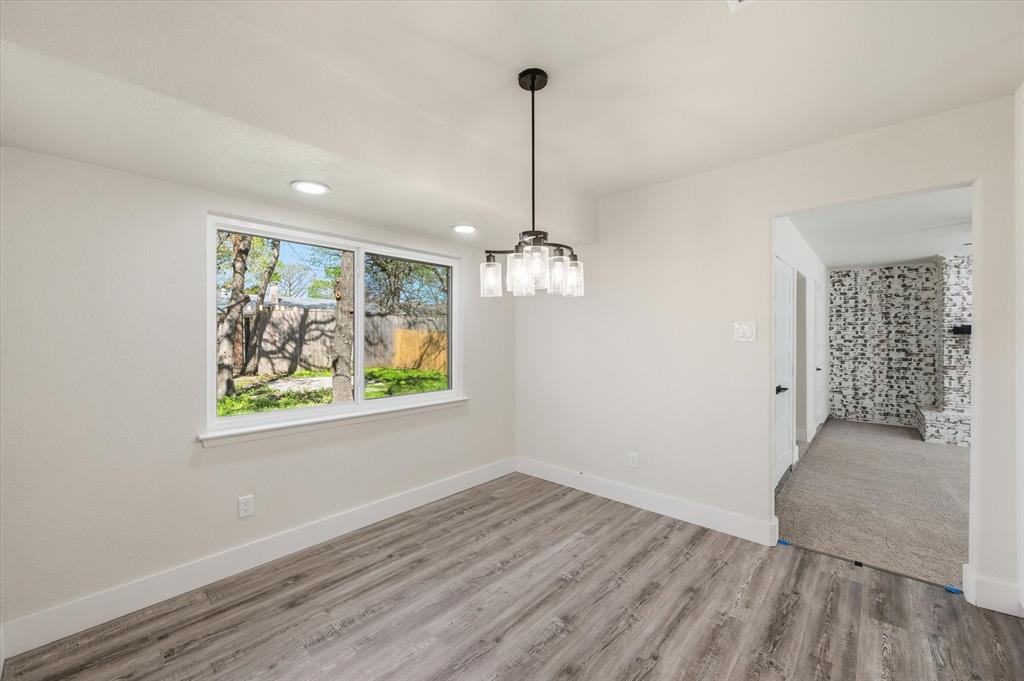 2804 Bent Tree Lane Arlington, TX 76016 - Photo 14 of 32 a view of a room with wooden floor chandelier and window