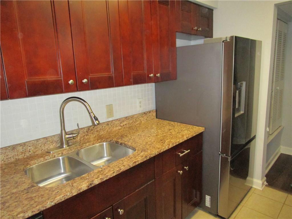4003 Wingate Way Sandy Springs, GA 30350 - Photo 12 of 29 a kitchen with granite countertop stainless steel appliances a sink and a counter space
