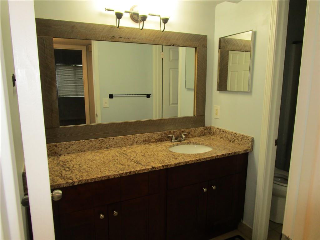 4003 Wingate Way Sandy Springs, GA 30350 - Photo 17 of 29 a bathroom with a granite countertop sink and a mirror