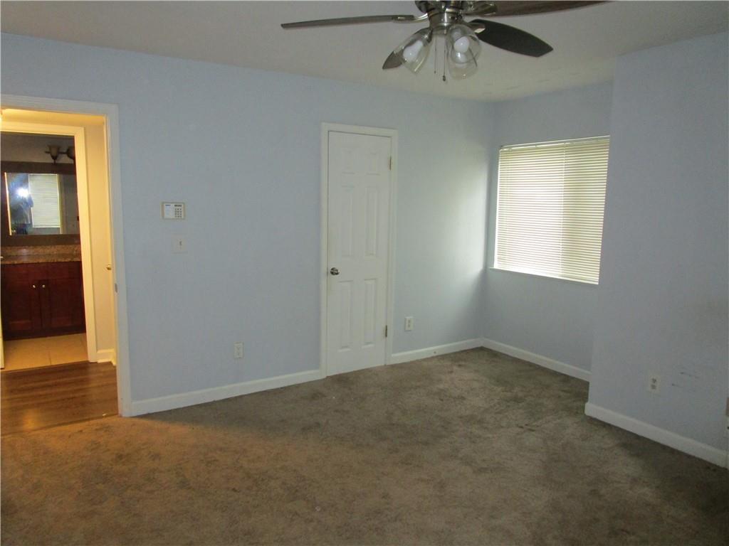 4003 Wingate Way Sandy Springs, GA 30350 - Photo 20 of 29 an empty room with a window and a chandelier fan