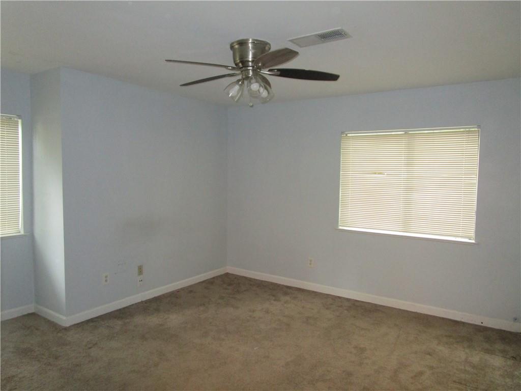 4003 Wingate Way Sandy Springs, GA 30350 - Photo 21 of 29 an empty room with a window and a fan