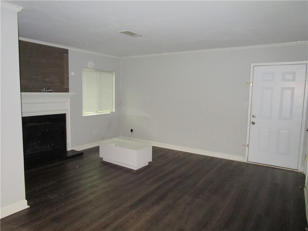 4003 Wingate Way Sandy Springs, GA 30350 - Photo 4 of 29 a view of empty room with wooden floor and fireplace