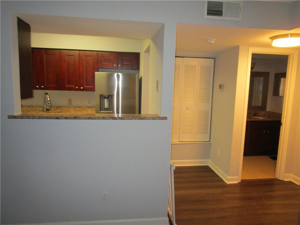 4003 Wingate Way Sandy Springs, GA 30350 - Photo 6 of 29 a view of a hallway with wooden floor and cabinet