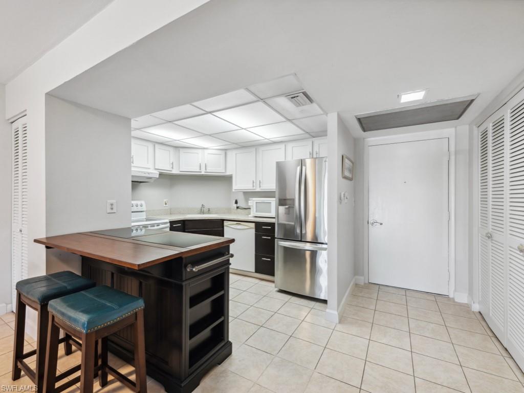 3 Bluebill Avenue, Unit 206 Naples, FL 34108 - Photo 8 of 19 a kitchen with a sink appliances and cabinets