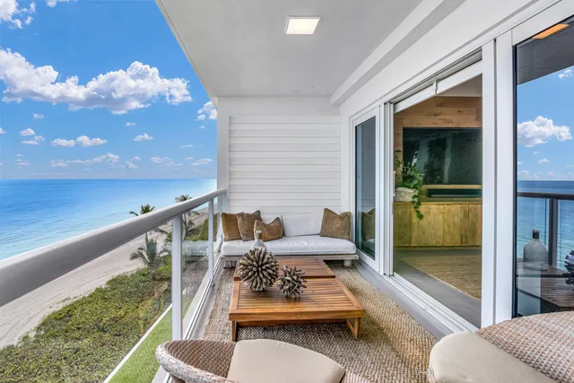a balcony with furniture and a potted plant