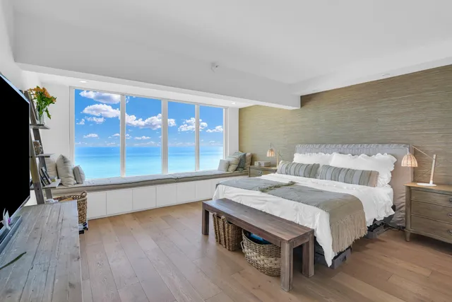 a spacious bedroom with a bed and a large window