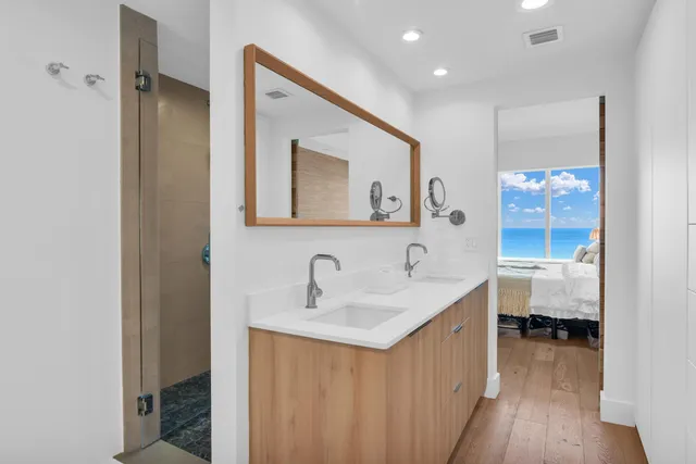 a en suite bathroom with a double vanity sink and a mirror