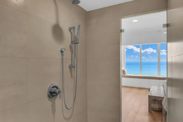 a bathroom with a glass shower door
