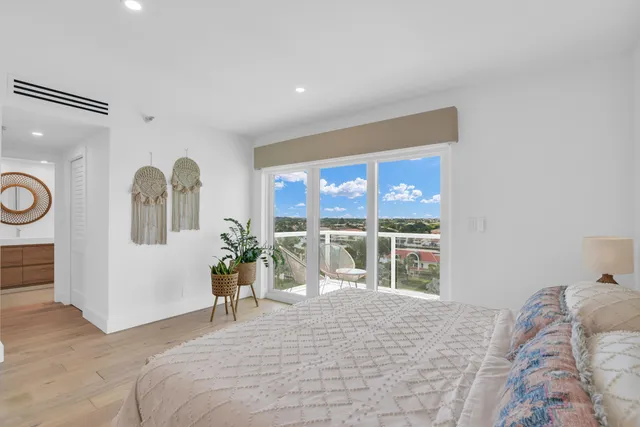 a bedroom with a large bed and a large window