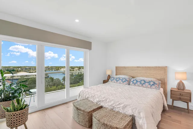 a large bed sitting in a bedroom next to a large window