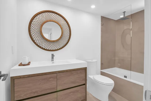 a bathroom with a sink a toilet and a shower