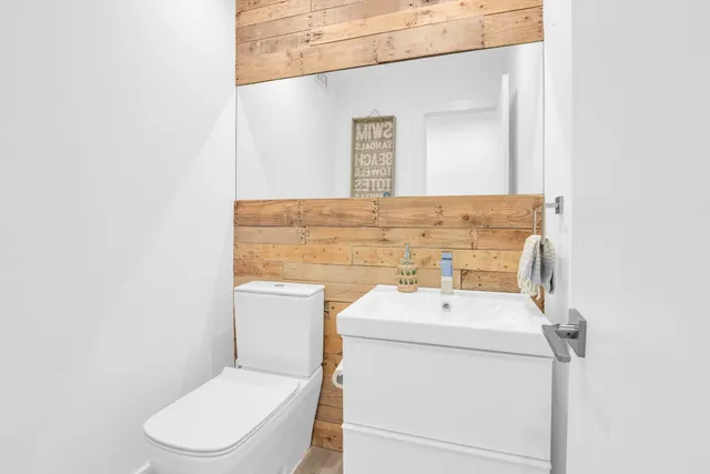a bathroom with a toilet sink and mirror