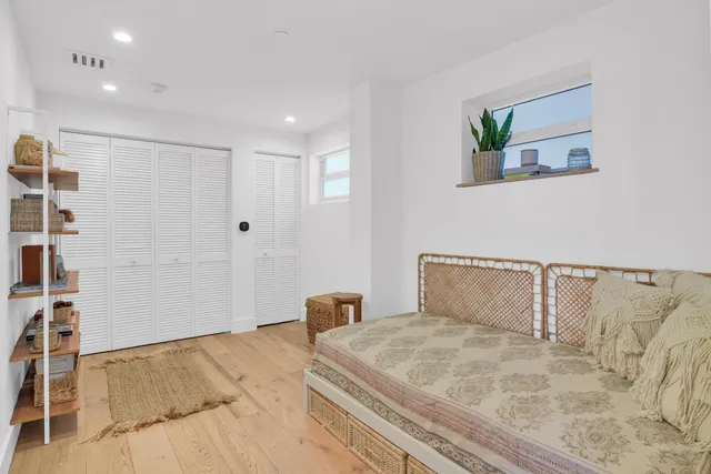 a bedroom with a large bed and painting on the wall