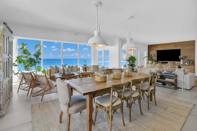 a dining room with furniture a chandelier and wooden floor