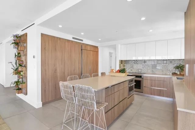 a kitchen with a stove a sink and a refrigerator