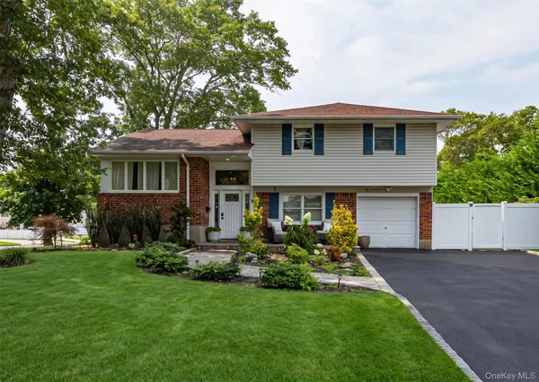 a front view of a house with a yard and trees