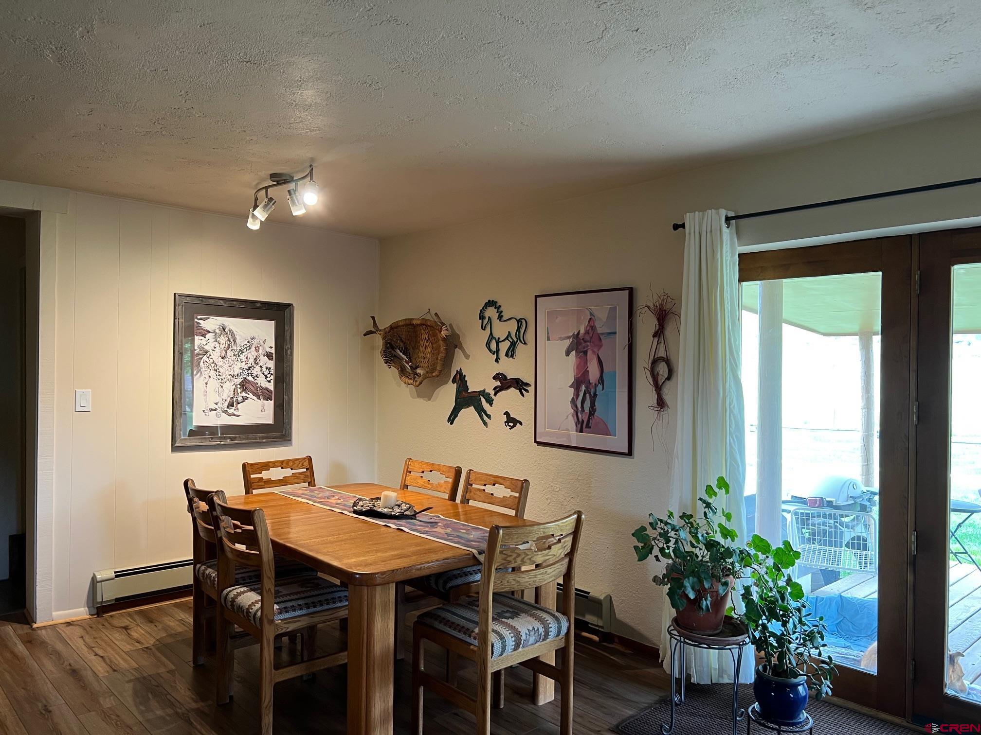 21446 Uncompahgre Road Montrose, CO 81403 - Photo 12 of 40 a view of a dining room with furniture window and wooden floor