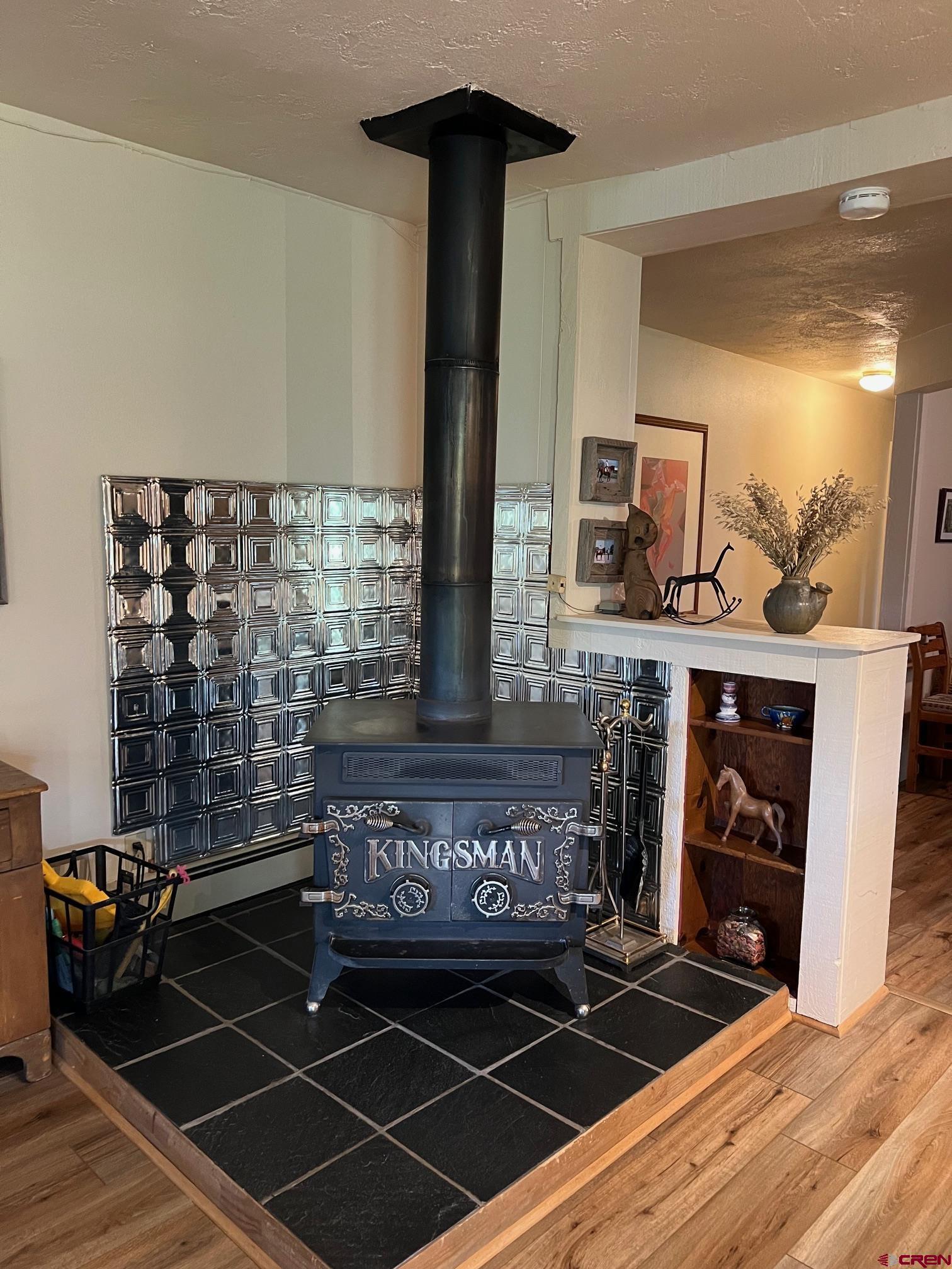 21446 Uncompahgre Road Montrose, CO 81403 - Photo 13 of 40 a living room with furniture a fireplace and a flat screen tv