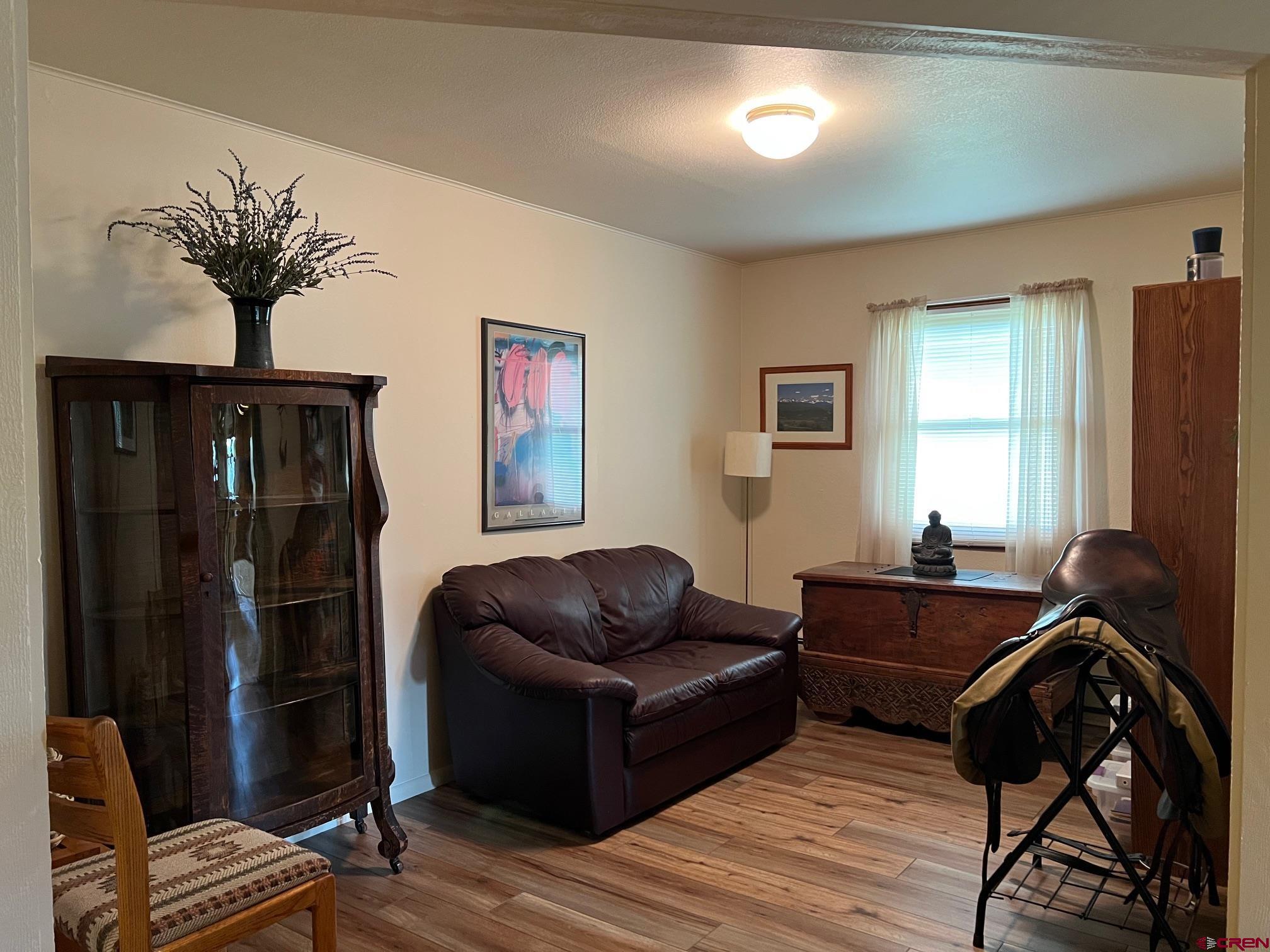 21446 Uncompahgre Road Montrose, CO 81403 - Photo 14 of 40 a living room with furniture and a flat screen tv
