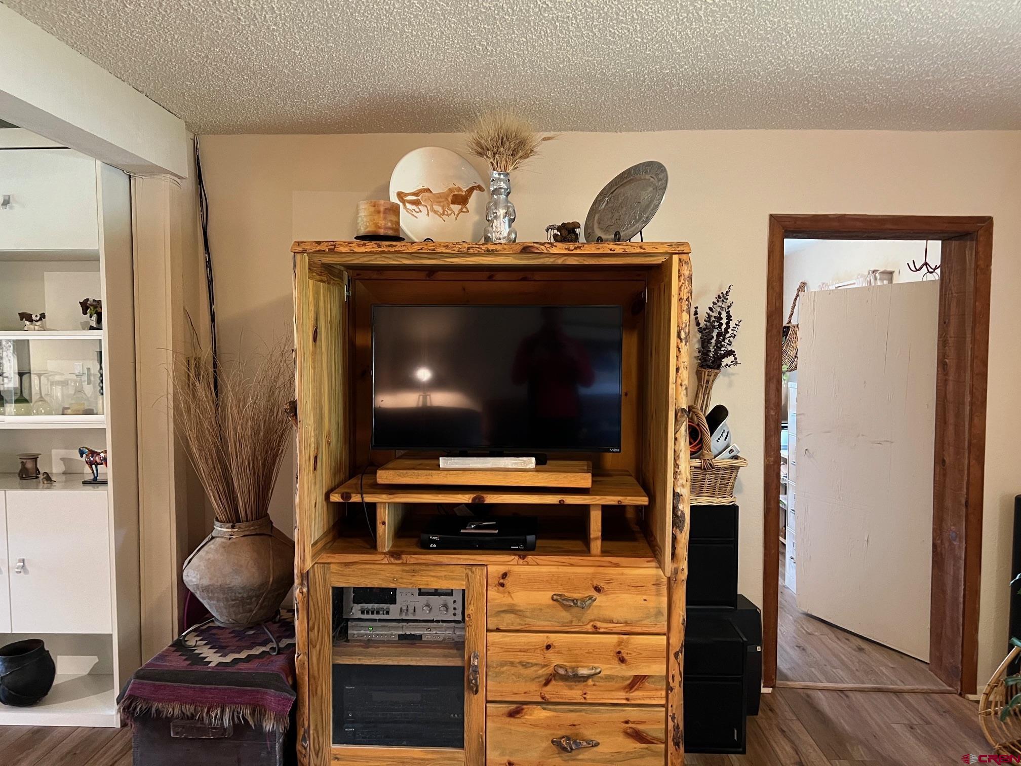 21446 Uncompahgre Road Montrose, CO 81403 - Photo 19 of 40 a living room with furniture and a flat screen tv